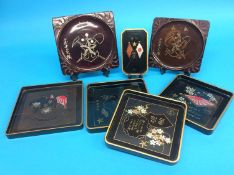 A collection of seven World War II Japanese lacquered sake trays