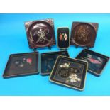 A collection of seven World War II Japanese lacquered sake trays