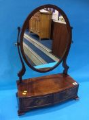 A reproduction mahogany toilet mirror