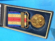 A collection of various British and Japanese medals, a tin whistle, with Japanese engraving etc.