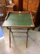 An oak campaign style folding writing table