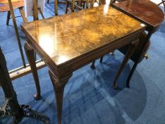 A walnut Queen Anne style fold over card table, with pad feet, 76cm wide