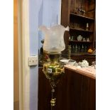 An oil lamp on telescopic brass stand