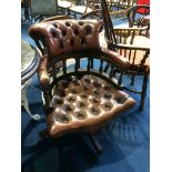 A brown leather Chesterfield office swivel chair