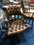 A brown leather Chesterfield office swivel chair