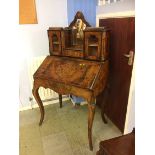 A Victorian walnut ladies writing desk with raised back, the fall front opens to reveal a fitted