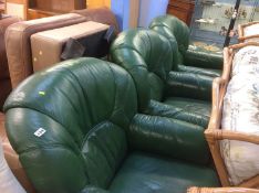 Three green leather armchairs