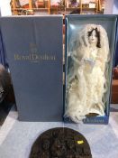 A boxed Royal Doulton doll on stand