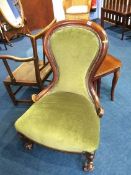 A mahogany spoon back nursing chair