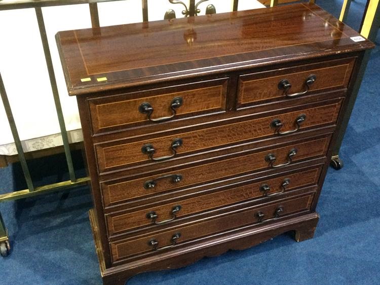 A narrow reproduction mahogany chest of drawers. 7