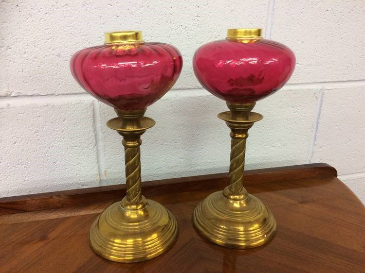 A pair of part oil lamps with cranberry reservoirs