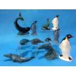 Four Poole pottery penguins, a whale, three seals, leaping salmon, a miniature dolphin and an