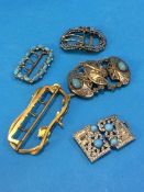 An Art Nouveau buckle and four other buckles