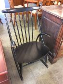 A Danish ebonised spindle back rocking chair