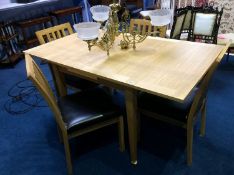 A modern light oak drawer leaf table and four single chairs