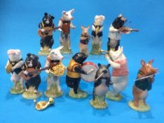 A collection of twelve Beswick Pig Band players (boxed)