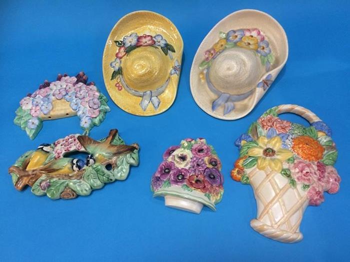 Two Beswick wall mounted bonnets, three Beswick wall mounted floral displays and a wall mounted