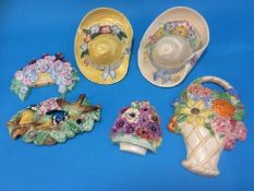 Two Beswick wall mounted bonnets, three Beswick wall mounted floral displays and a wall mounted