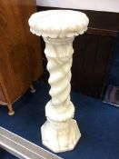 An Alabaster pedestal with circular top and barley twist column