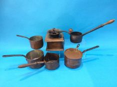 Four copper pans, a cast iron pan and a coffee grinder