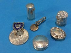 A silver dollar, money clip, fob and various pill pots