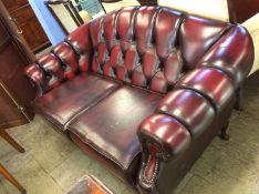A Chesterfield oxblood two seater settee