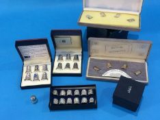 A collection of boxed silver thimbles