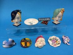 A Royal Doulton Art Deco mask, HN1612, five Poole pottery brooches, two Art Deco mask napkin ring