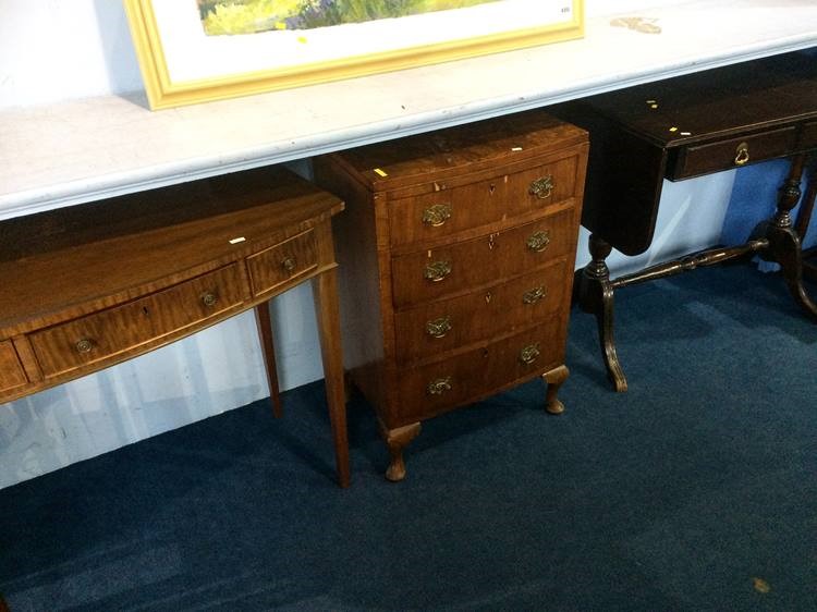 Walnut bow front chest of drawers, a side table an