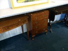 Walnut bow front chest of drawers, a side table an