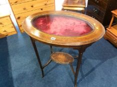 An oak oval bijouterie table, with inset glass top