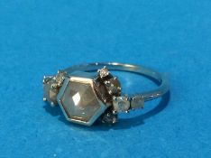 A white metal ring, stamped '585', mounted with a 'grey' diamond, size K