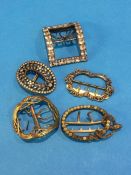 An Art Nouveau style buckle and four other buckles