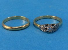 An 18ct gold wedding band and another ring, stamped '18ct', size L