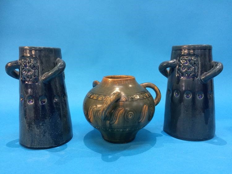 A pair of Adamask three handled vases, on a mottled blue ground and a small squat shaped three