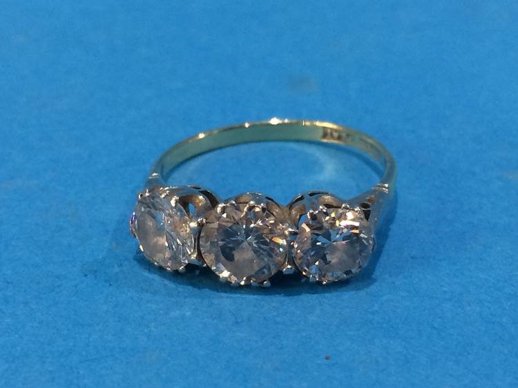 An 18ct gold three stone diamond ring