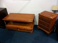 A yew wood coffee table, a yew wood chest of drawers and a mahogany cabinet