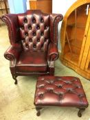 A Chesterfield high back wing armchair and a foots