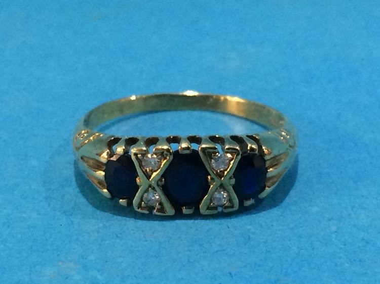 A gold ring, mounted with diamonds and sapphires, size P