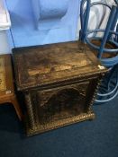 A small carved oak single door cabinet