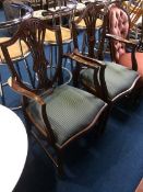 A pair of reproduction mahogany Chapmans 'Siesta' carver chairs