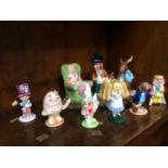 Royal Doulton Beswick Ware 'Mad Hatters Tea Party' group and six 'Alice in Wonderland' figures