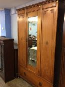An oak mirror door wardrobe