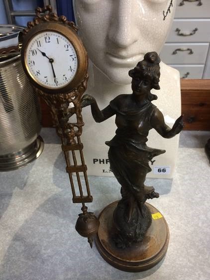 An early 20th century Spelter clock, the clock movement balanced on the Ladies hand - Image 2 of 3