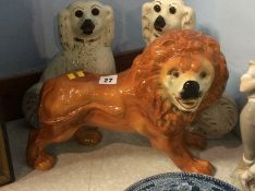 A pair of Staffordshire Spaniels and a Victorian standing Lion