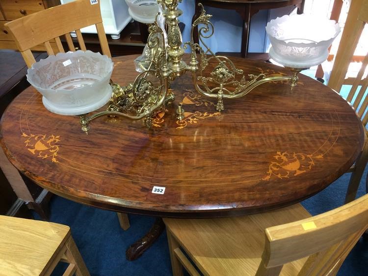 A Victorian walnut oval centre table