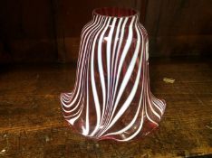 A cranberry and white glass shade