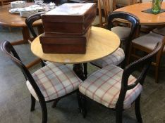 A tripod table and four chairs