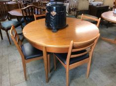 A teak circular table and four chairs