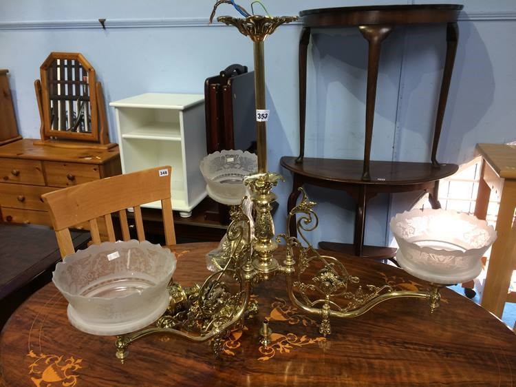 A hanging brass three light chandelier with frosted glass shades